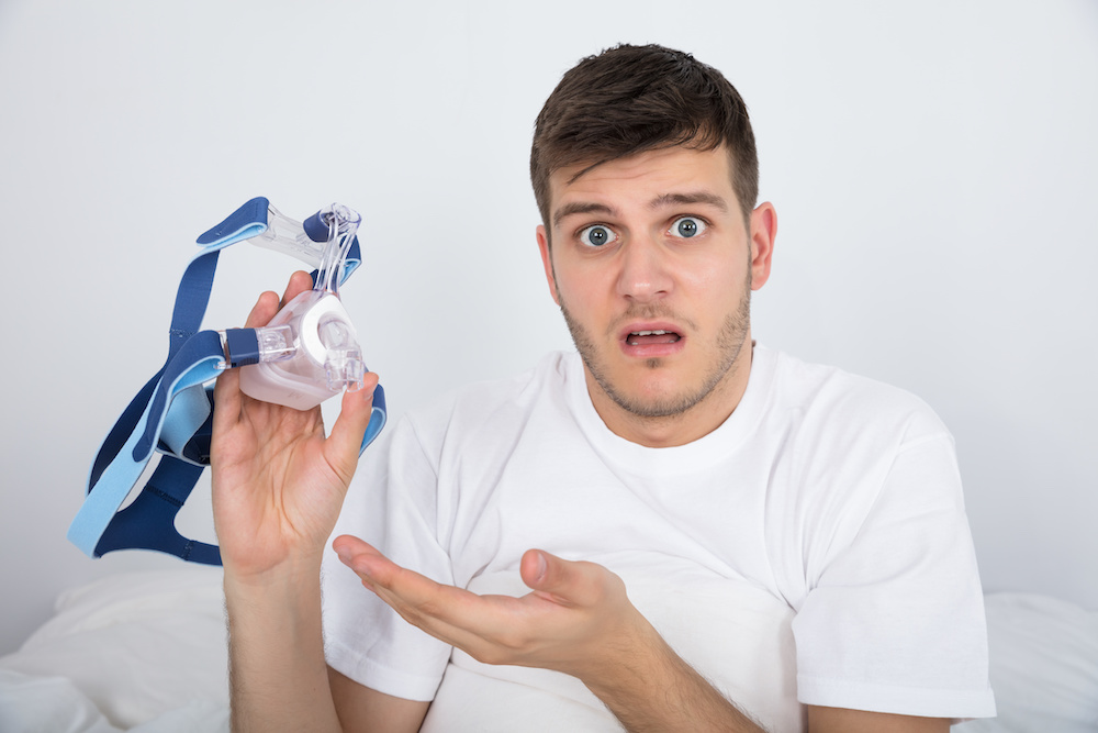 man holding a cpap machine